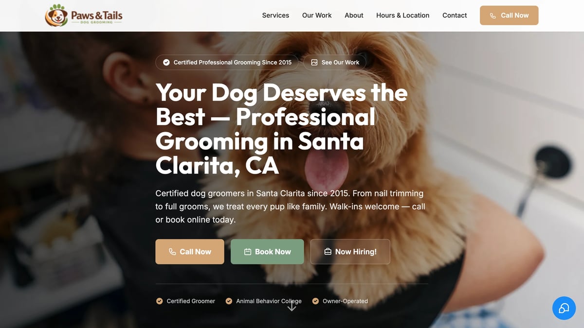 Professional dog groomer gently washing a small tan dog, with website header for Paws and Tails grooming services in Santa Clarita, CA.